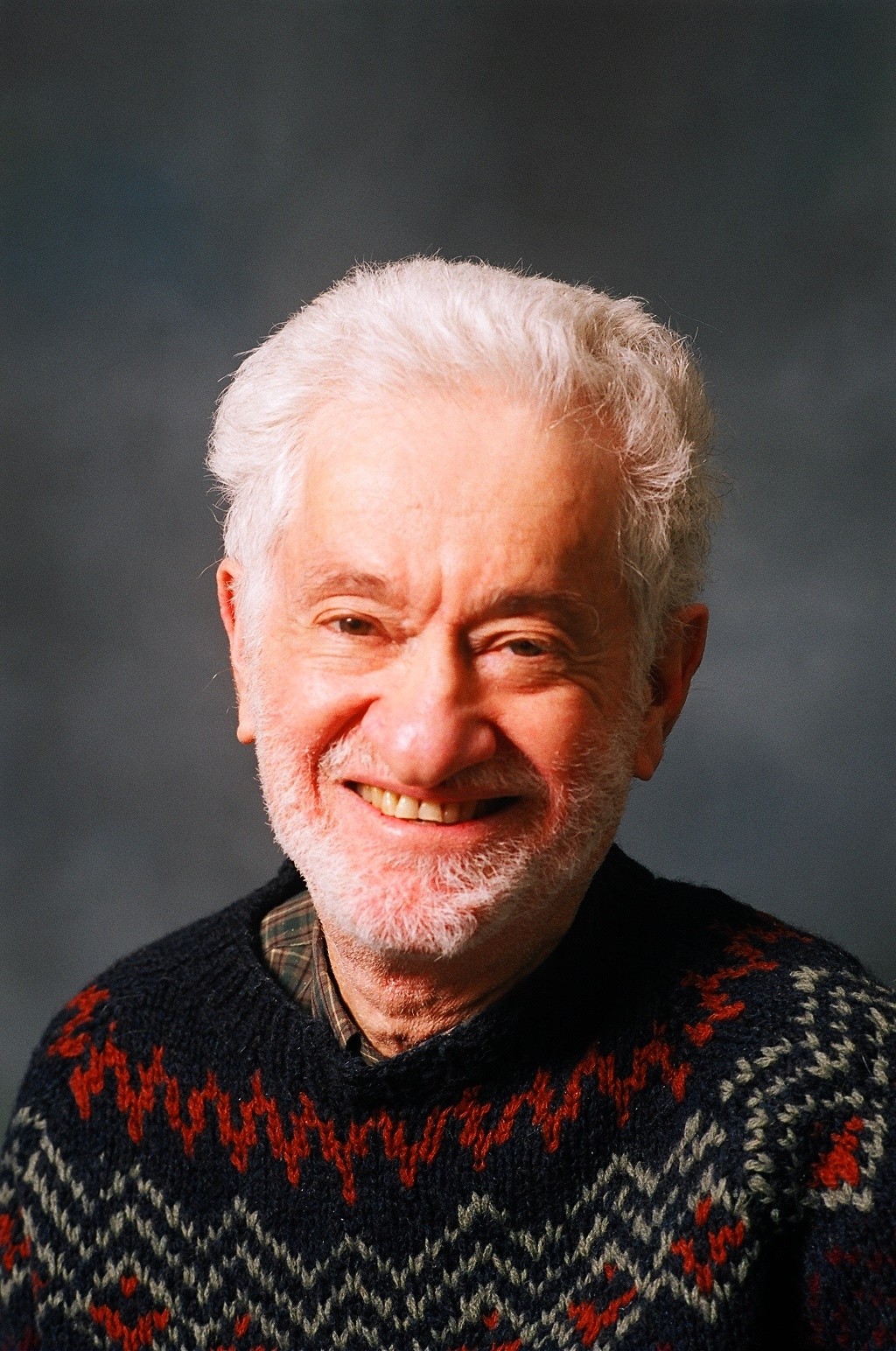 Stephen H. Unger poses in a festive sweater