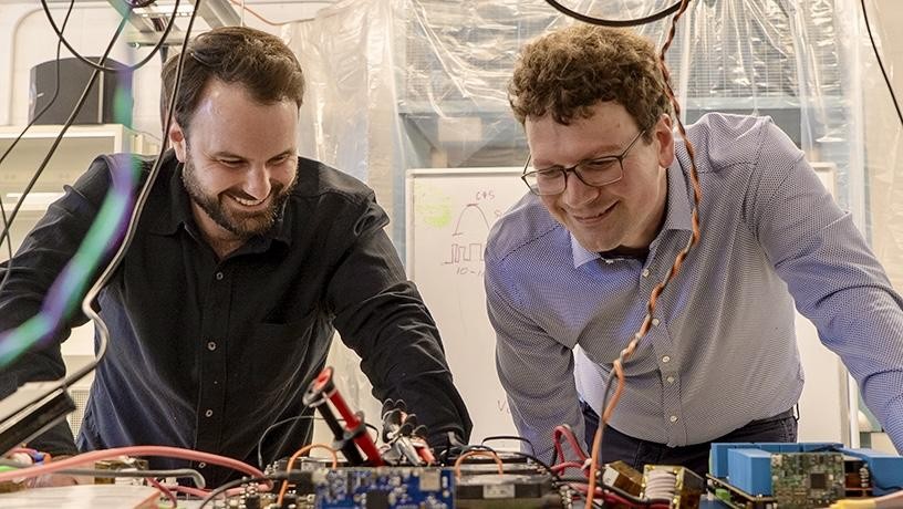 Matthias Preindl (right) and Wesley Pennington discuss software-defined power electronics in MPlab.