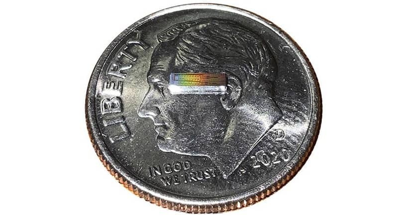 Photonic integrated chip capable of encoding data on 32 independent frequency channels on a U.S. dime for scale. Credit: Lightwave Research Laboratory/Columbia Engineering