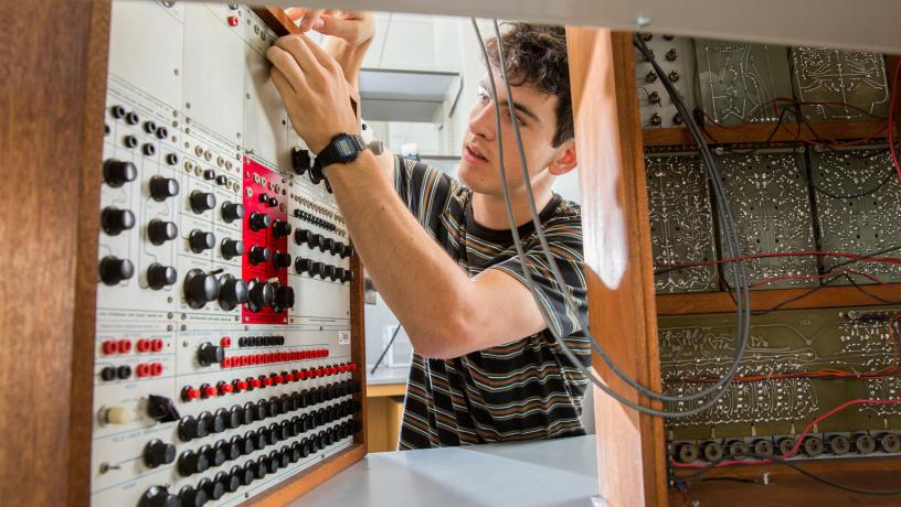 Electrical engineering student Luis Collado picked up conservation techniques while working in an instrument repair shop.