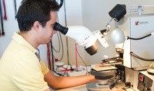 Man looking through microscope