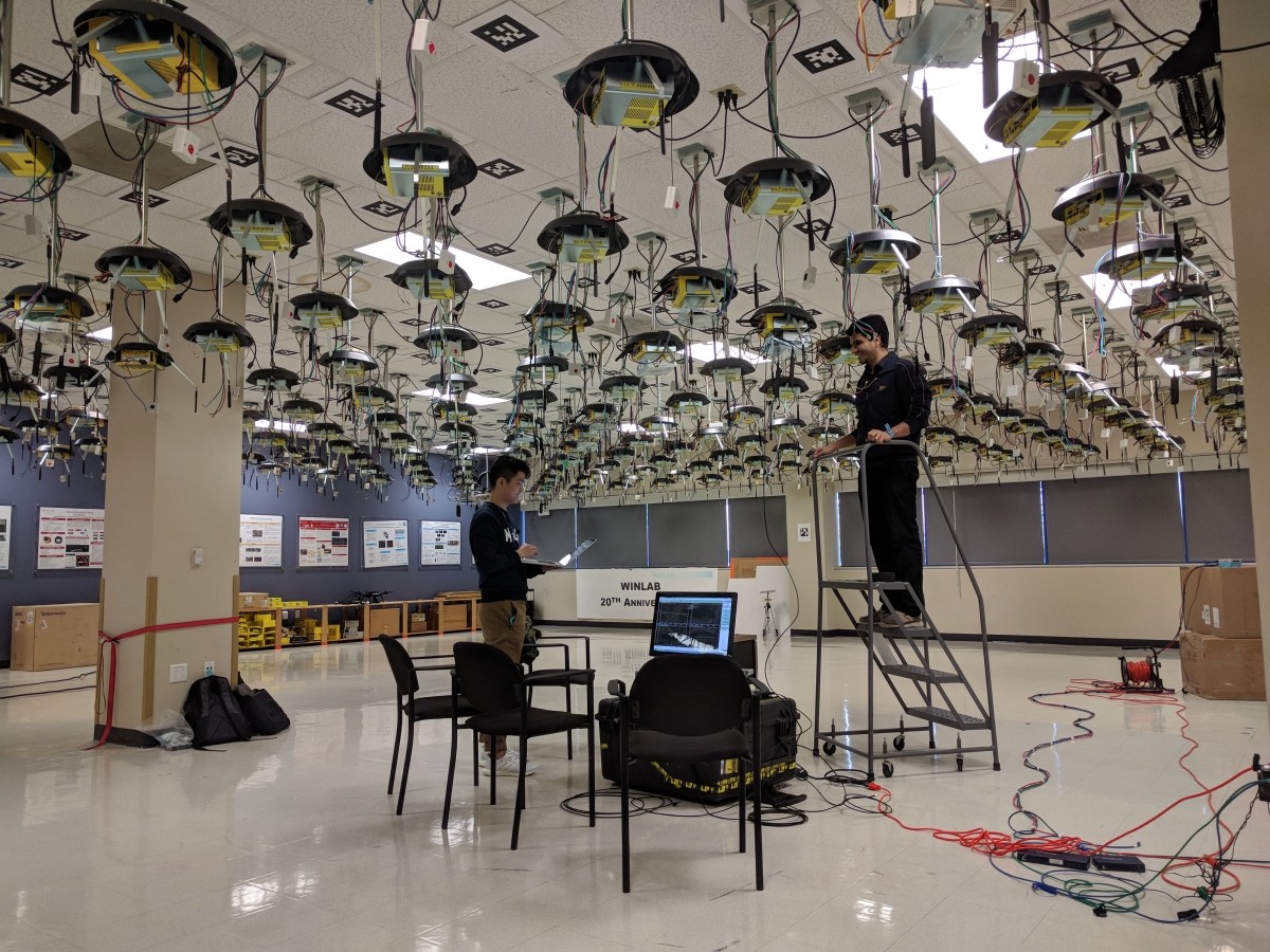 Electrical Engineering Ph.D. students Tingjun Chen and Mahmood Baraani Dastjerdi install a full duplex wireless device in the ORBIT testbed at Rutgers University