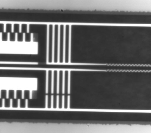 Video of the high-precision micro-electromechanical system (MEMS) used to control the distance between two beams at different temperatures. The video is taken under a high magnification microscope. The whole video frame dimension is comparable to the diameter of a a strand of human hair.