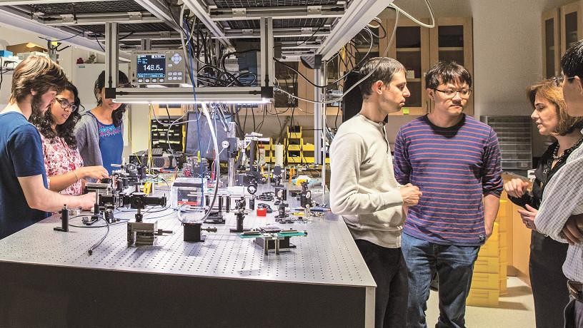 Lipson (far right) consulting with some of the more than 20 students working in her lab.