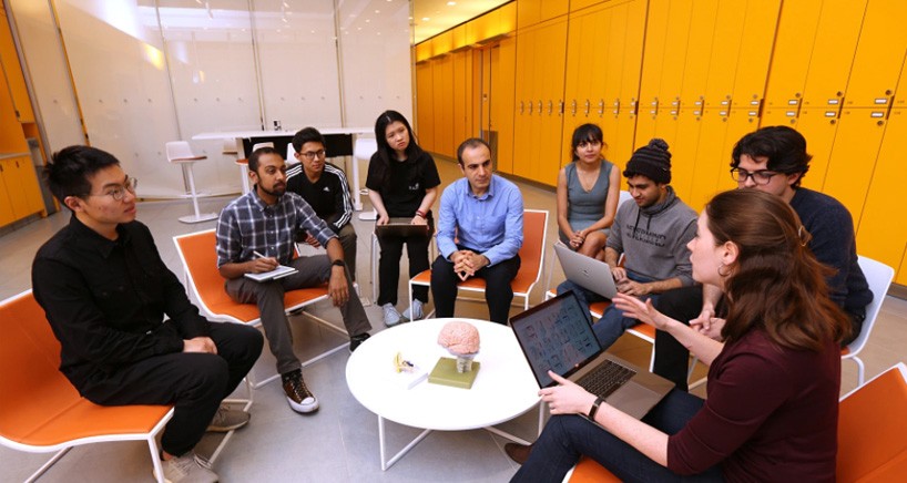 With their vocoder, Mesgarani and members of his Neural Acoustic Processing Lab developed the first system capable of directly translating human thought into intelligible, recognizable speech. (photo by John Abbott) Group of people in school setting