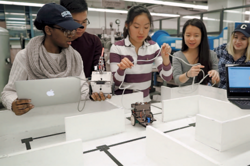 Student teams build robots to navigate a maze. (Photo by Jane Nisselson)
