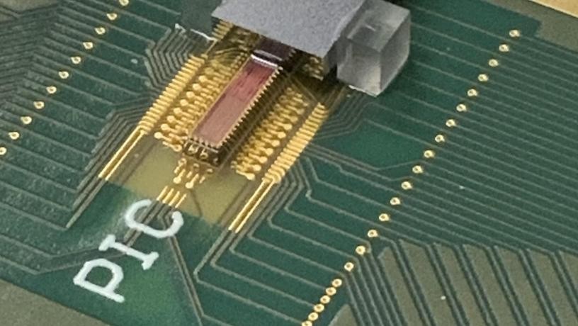 Photonic transmitter chip mounted on a printed circuit board with electrical and fiber optic connections. Credit: Lightwave Research Laboratory/Columbia Engineering