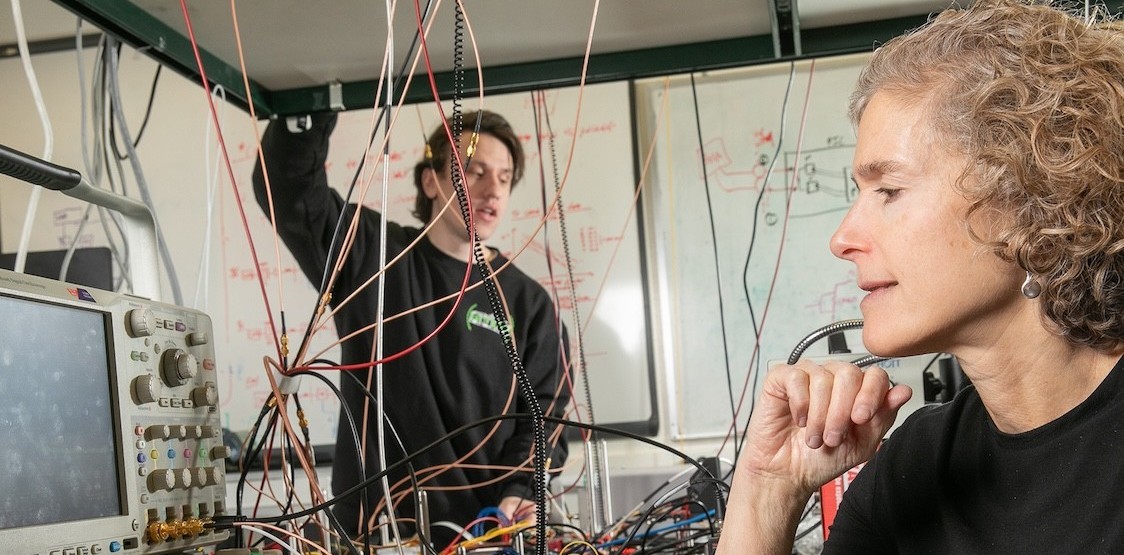 Michael Cullen, electrical engineering graduate student and co-author of the paper, works with Keren Bergman (foreground) in the Lightwave Research Laboratory. Credit: Timothy Lee/Columbia Engineering