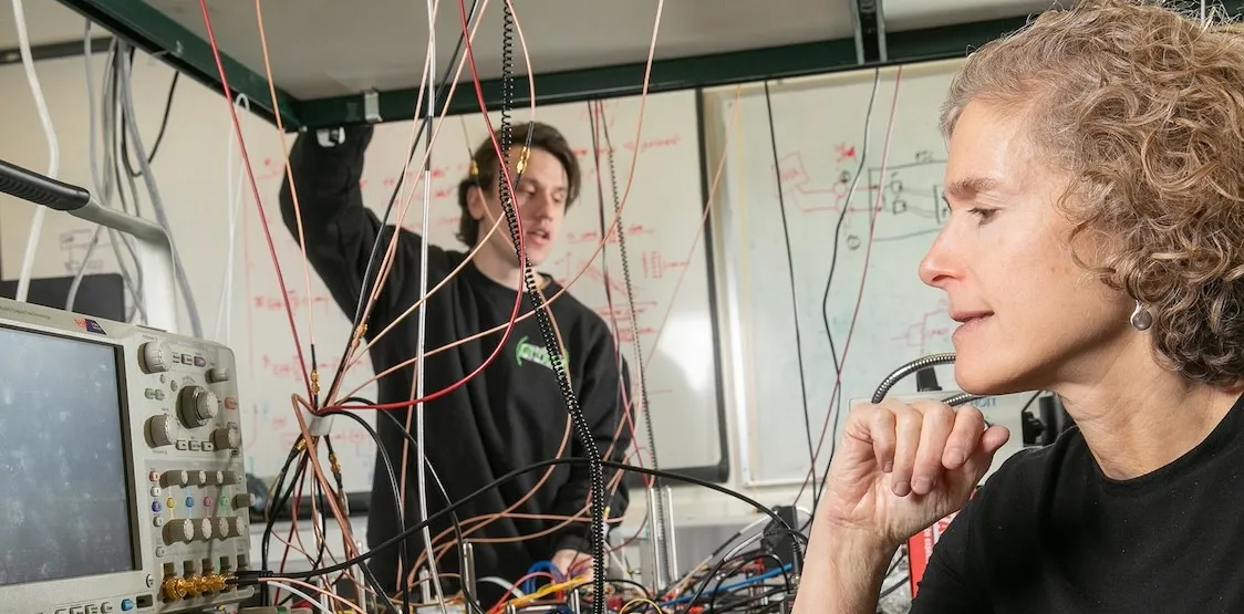 Michael Cullen, electrical engineering graduate student and co-author of the paper, works with Keren Bergman (foreground) in the Lightwave Research Laboratory. Credit: Timothy Lee/Columbia Engineering
